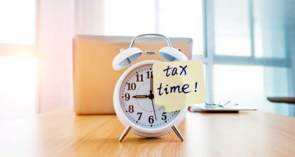 Alarm clock with tax time sticky note
