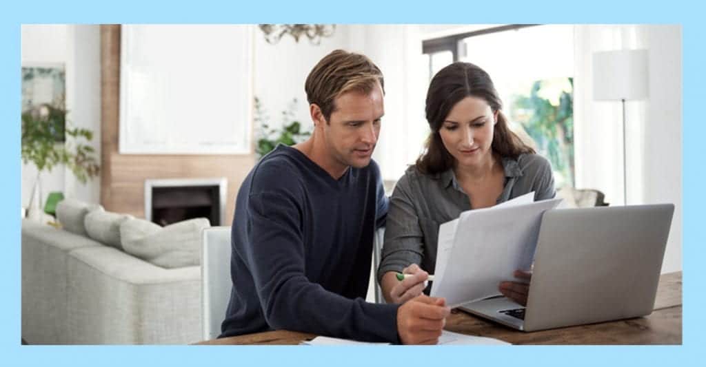 Middle Aged Couple looking at legal paper and laptop regarding their trust fund