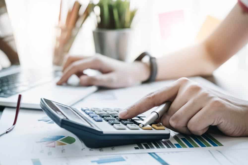 Woman Computing Her Finances Using Calculator